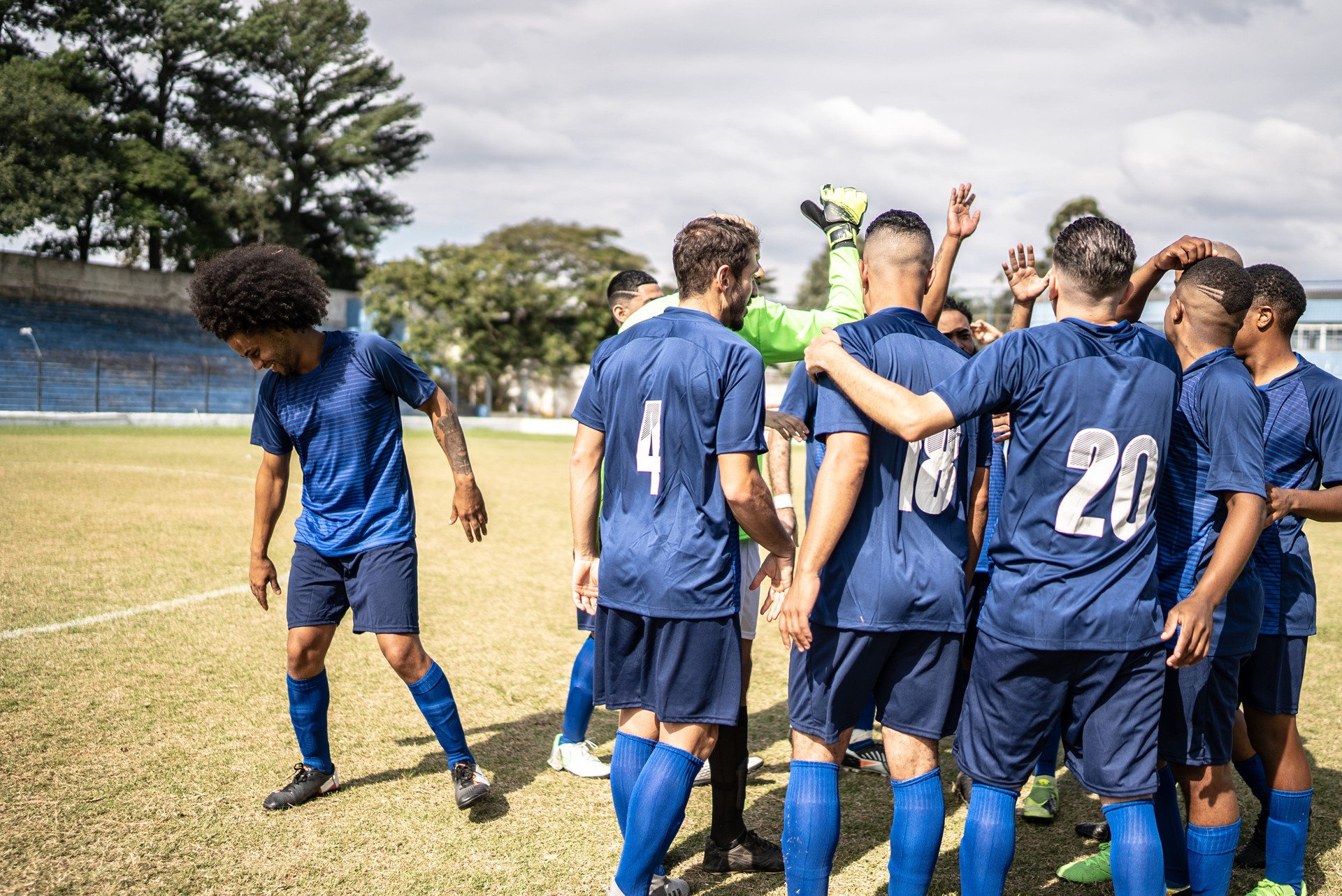 Soccer team huddling before a match