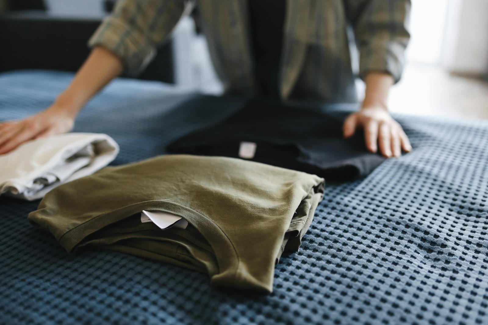 A stack of folded custom apparel